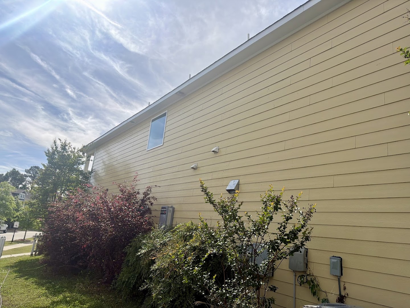 A freshly soft-washed home exterior under a clear central Alabama sky